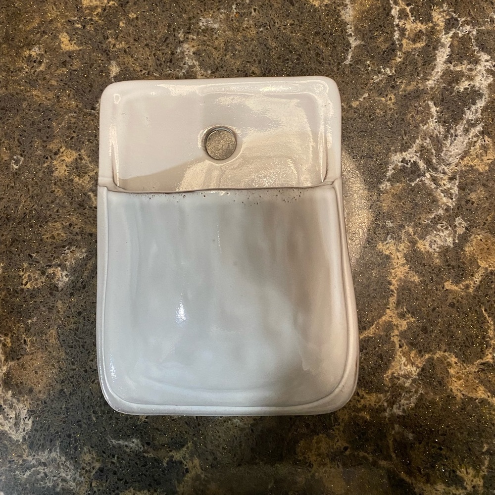 White ceramic “pocket” wall decor